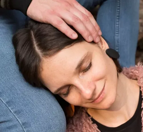Person relaxing during a guided hypnotherapy session